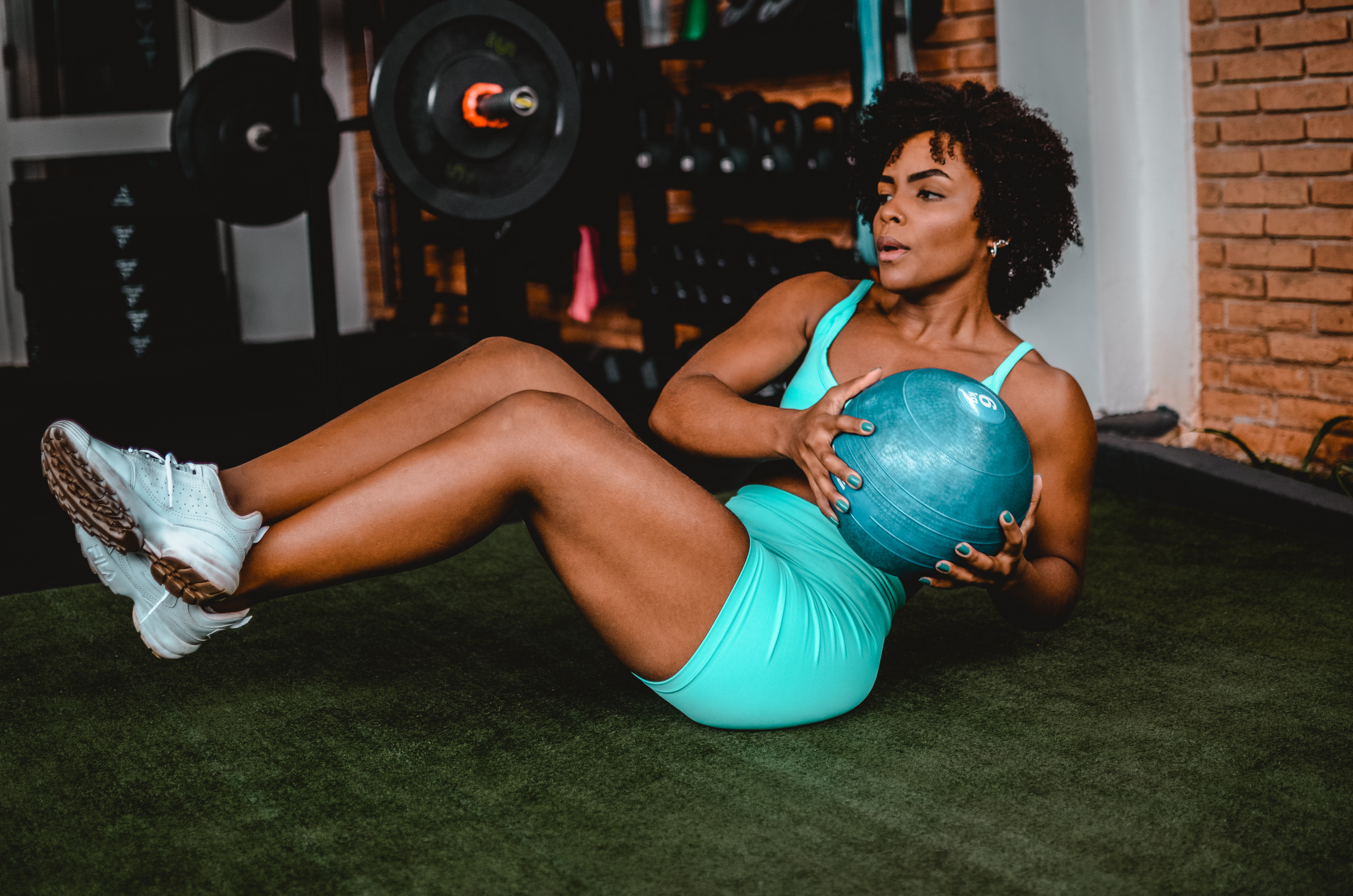 Woman sitting doing exercise with the ball