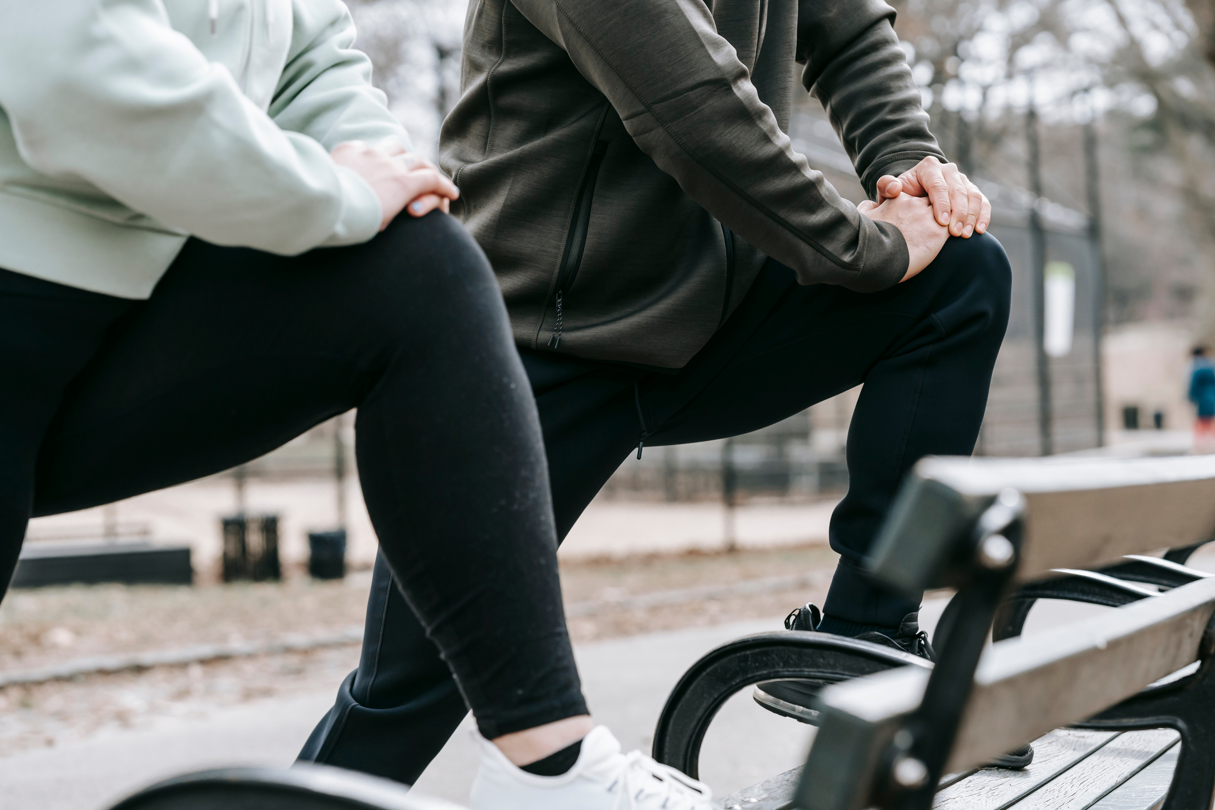 Sportive people training on street in park
